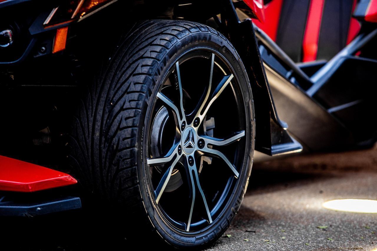 Close-up of a tire sidewall showing the structural ply exposed by a puncture